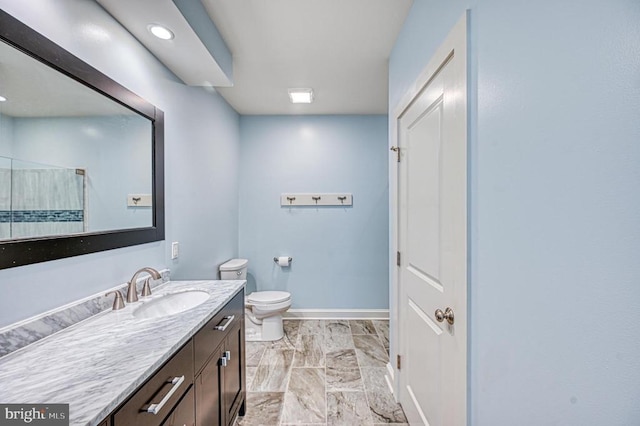 bathroom featuring vanity and toilet