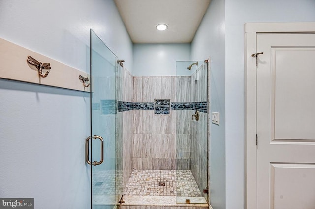 bathroom with a shower with shower door