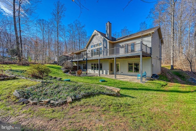 rear view of house with a yard and a patio