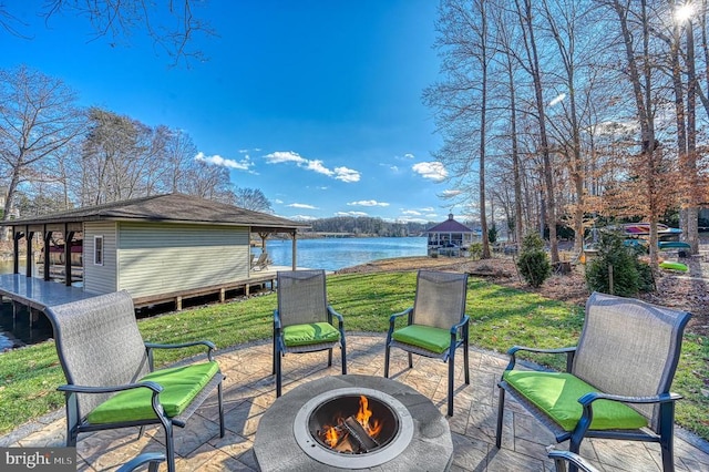 view of patio with a water view and an outdoor fire pit