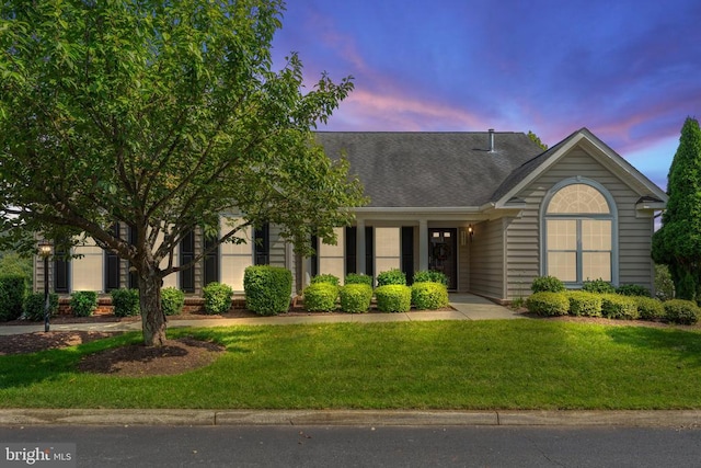 view of front of home with a lawn