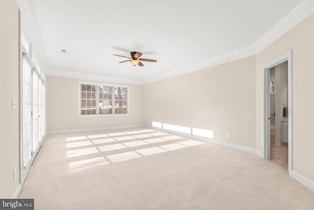 interior space featuring ceiling fan, light colored carpet, and crown molding