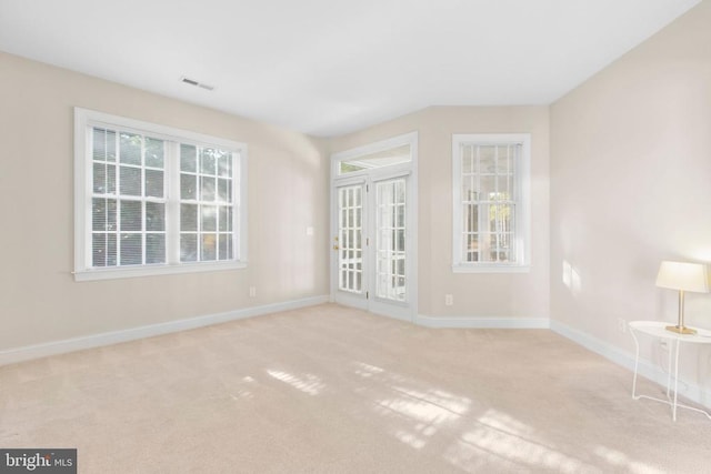 spare room with light colored carpet