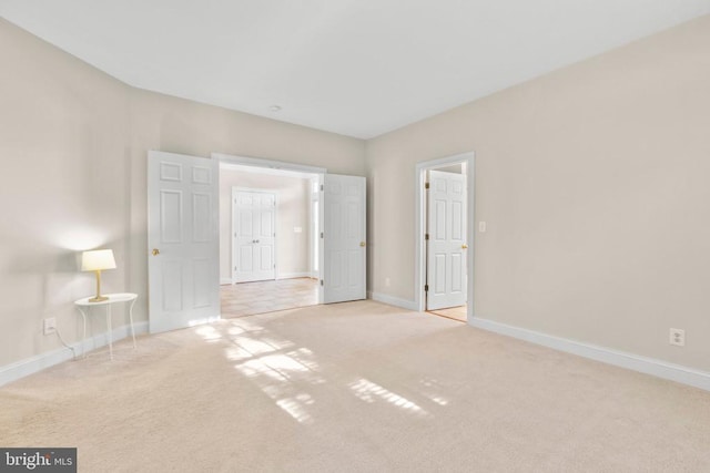 unfurnished room with light carpet