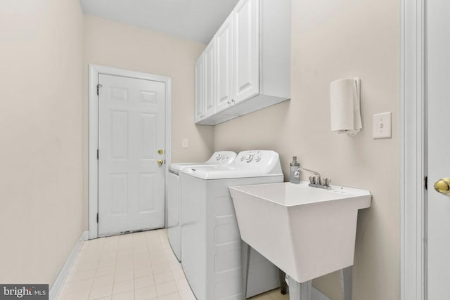 clothes washing area featuring cabinets, independent washer and dryer, and sink