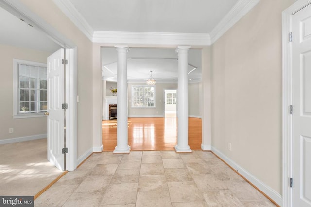 interior space with ornamental molding and decorative columns