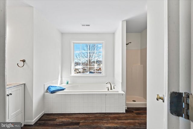 bathroom featuring shower with separate bathtub, hardwood / wood-style flooring, and vanity