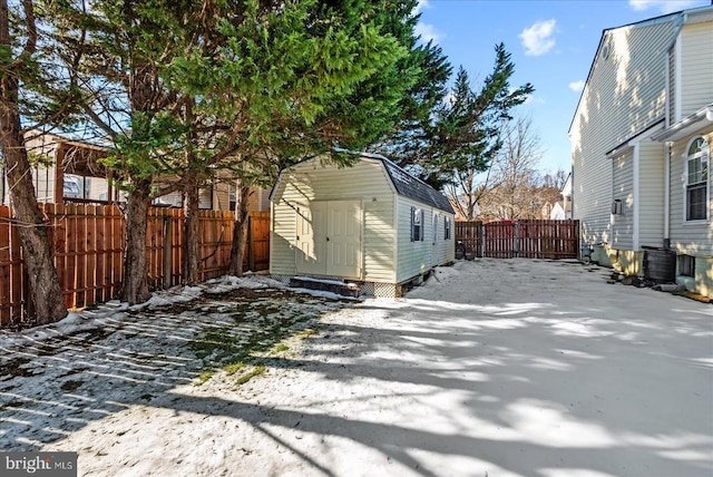 view of side of home featuring a storage shed