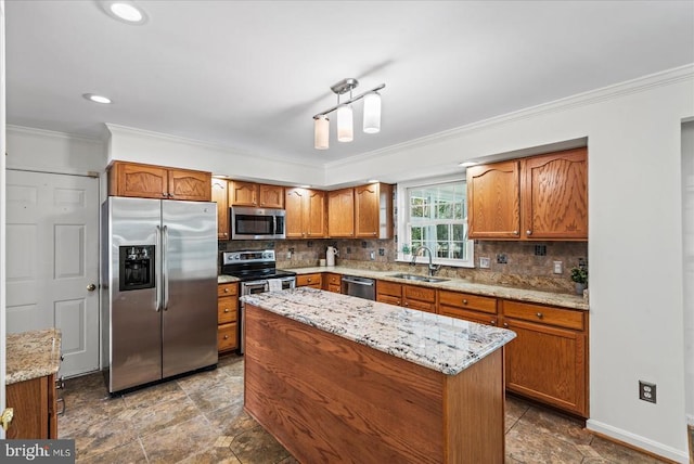 kitchen with backsplash, a center island, sink, light stone countertops, and appliances with stainless steel finishes