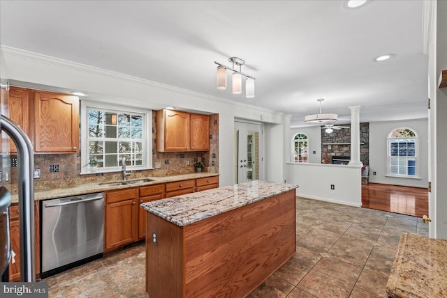 kitchen featuring dishwasher, a center island, decorative backsplash, ornamental molding, and ceiling fan