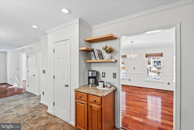 kitchen featuring light stone counters and ornamental molding