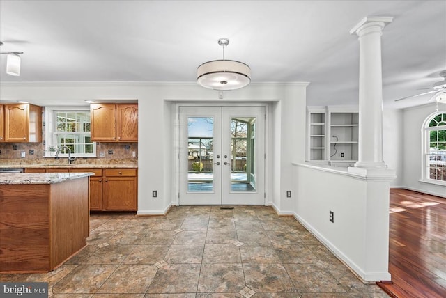 kitchen featuring decorative backsplash, ceiling fan, ornate columns, and french doors