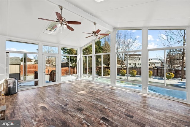 unfurnished sunroom with ceiling fan and lofted ceiling with skylight