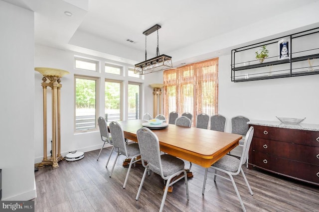 dining space with wood-type flooring