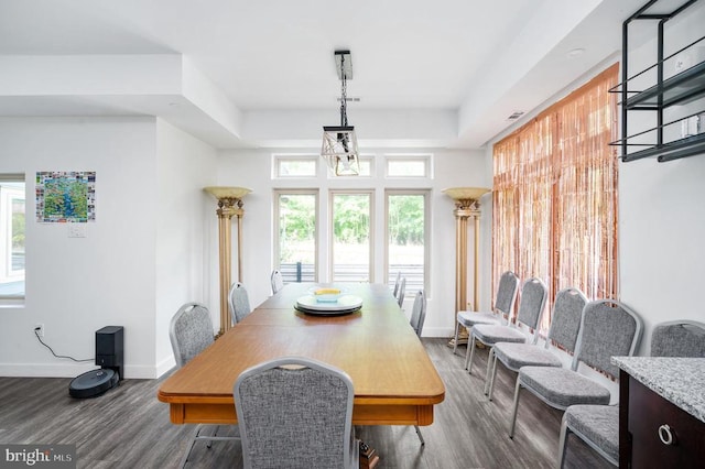 dining area featuring hardwood / wood-style floors and a notable chandelier