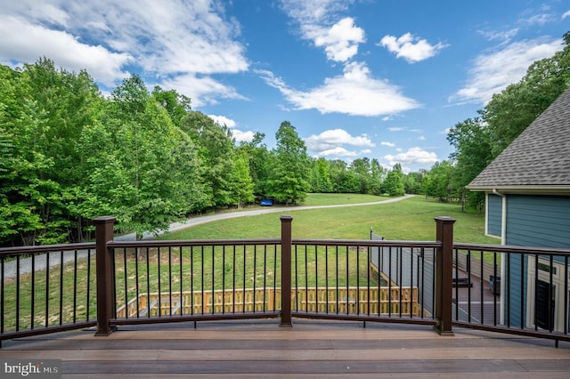 wooden deck with a lawn