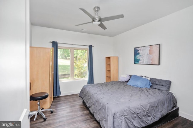 bedroom with dark hardwood / wood-style floors and ceiling fan