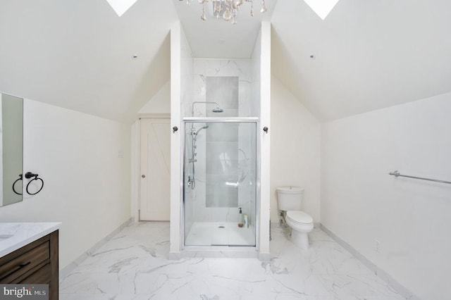 bathroom with vanity, toilet, a shower with door, and a skylight