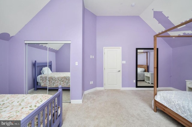 bedroom with a closet, light colored carpet, and lofted ceiling