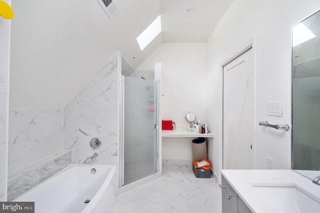 bathroom featuring vanity, independent shower and bath, and vaulted ceiling with skylight