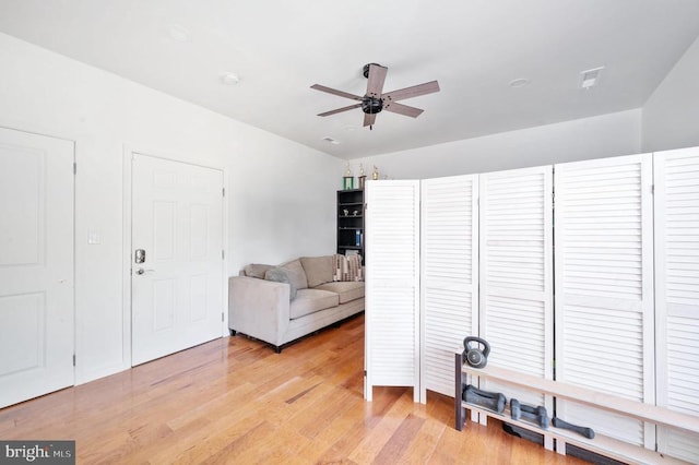 living room featuring ceiling fan and light hardwood / wood-style floors