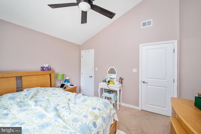 bedroom with ceiling fan, light carpet, and vaulted ceiling