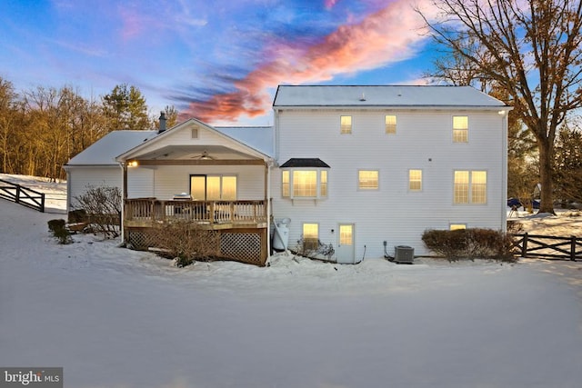 snow covered back of property featuring ceiling fan, a wooden deck, and cooling unit