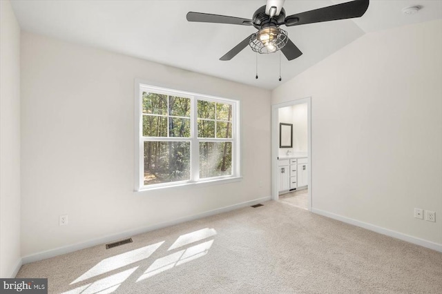 carpeted empty room with ceiling fan and lofted ceiling