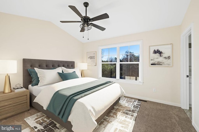 carpeted bedroom with vaulted ceiling and ceiling fan