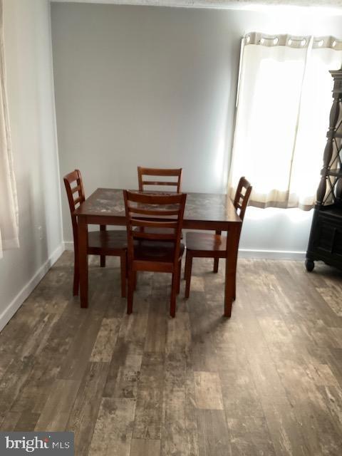 dining space featuring dark hardwood / wood-style floors