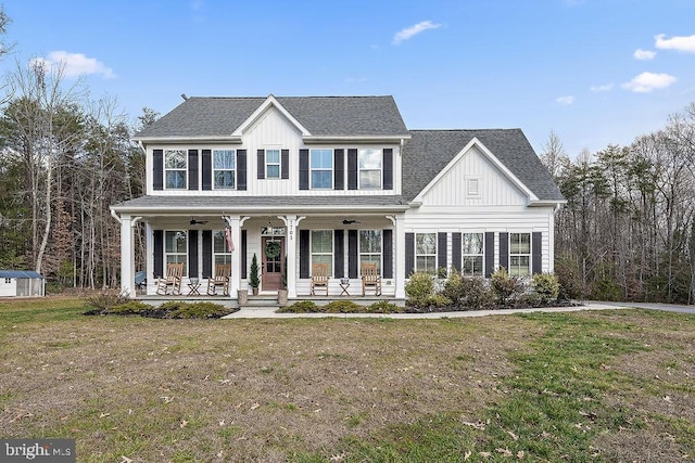 view of front of house with a front yard, a porch, and ceiling fan