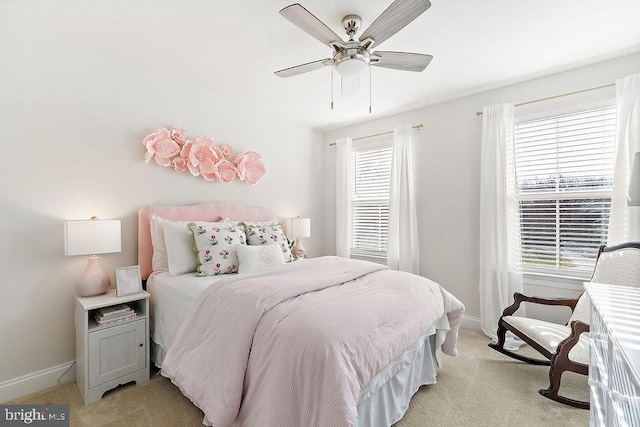 bedroom with multiple windows, light colored carpet, and ceiling fan