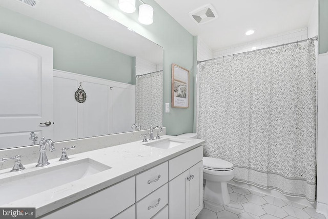 bathroom with tile patterned floors, vanity, and toilet