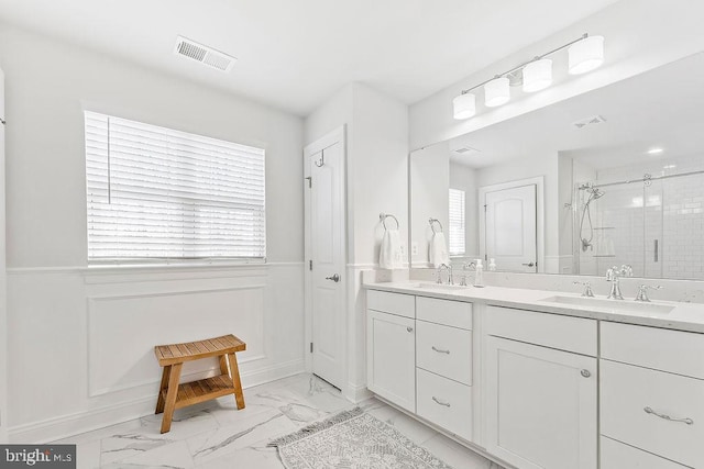 bathroom featuring vanity and a shower with door