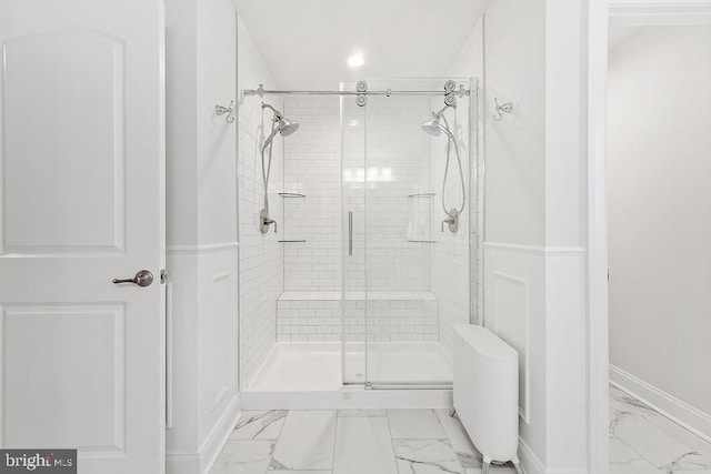 bathroom with a shower with door