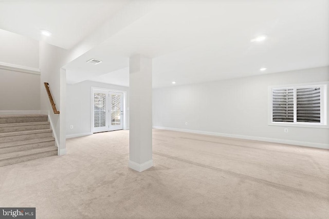 basement with light carpet and french doors