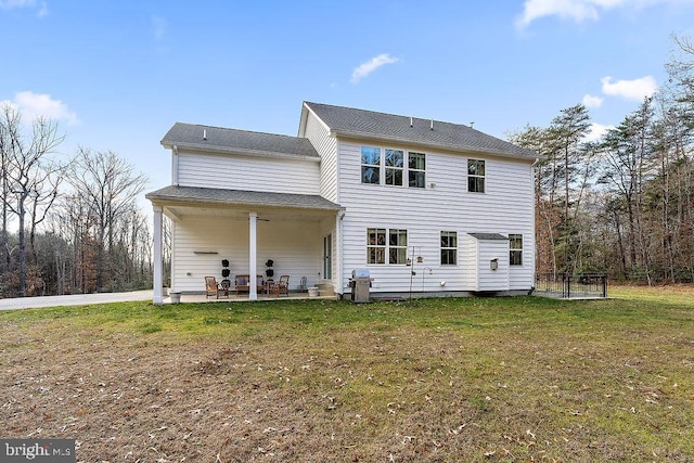 back of property featuring a yard and a patio