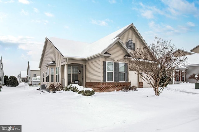 view of front of house with central AC and a garage