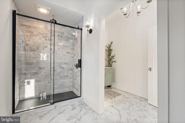 bathroom featuring a shower with door and an inviting chandelier