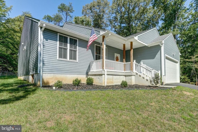 view of front of home with a front lawn, covered porch, and a garage