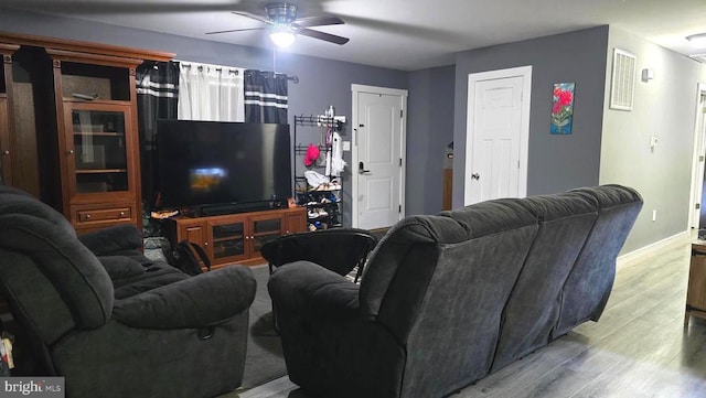 living room featuring light hardwood / wood-style floors and ceiling fan