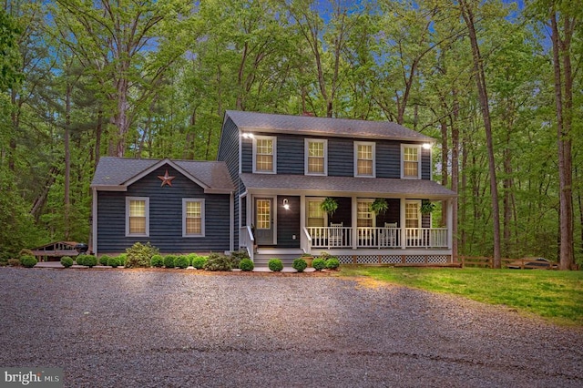 colonial home featuring covered porch