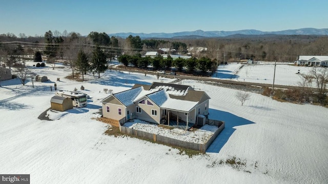 snowy aerial view featuring a mountain view