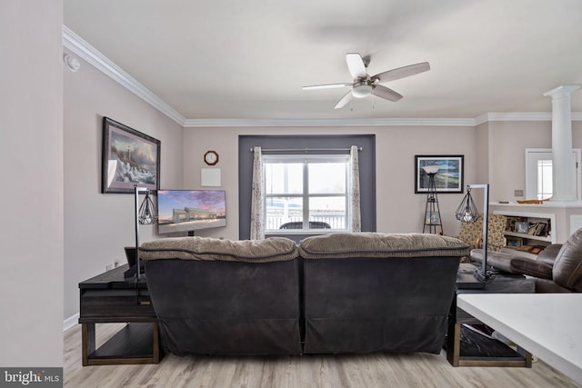 living room featuring ceiling fan, crown molding, and light hardwood / wood-style flooring