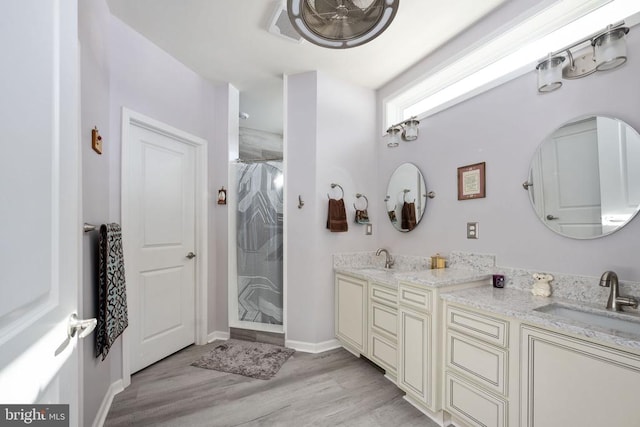 bathroom with vanity, hardwood / wood-style floors, and a shower