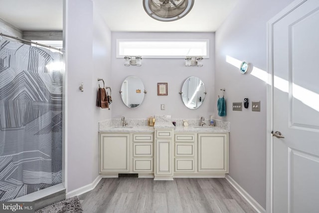 bathroom with vanity, walk in shower, and hardwood / wood-style floors