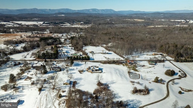 snowy aerial view with a mountain view