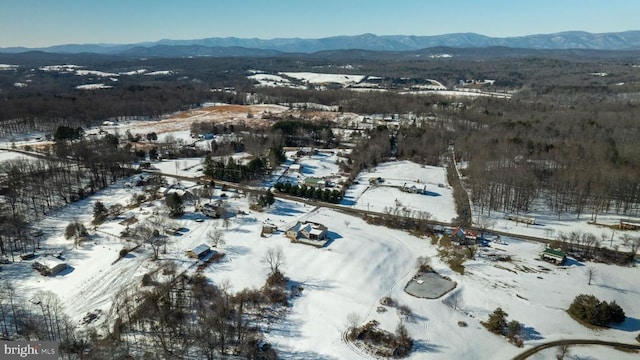 snowy aerial view featuring a mountain view