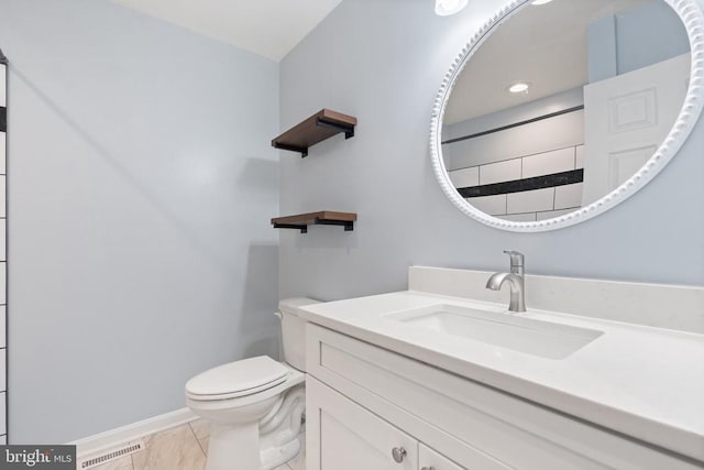 bathroom with tile patterned floors, vanity, and toilet