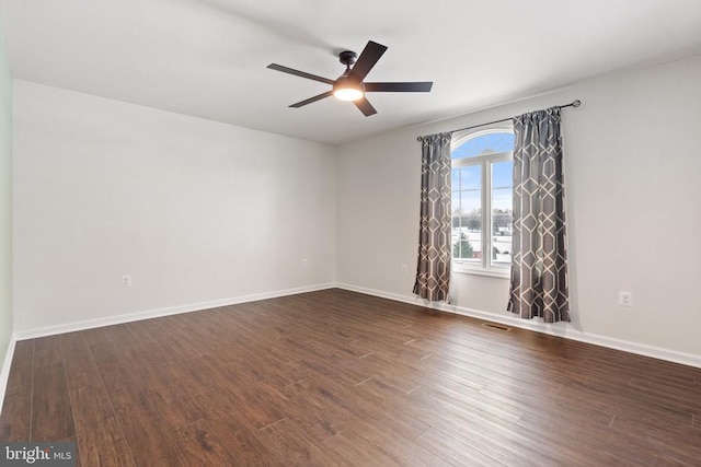 unfurnished room with dark hardwood / wood-style flooring and ceiling fan